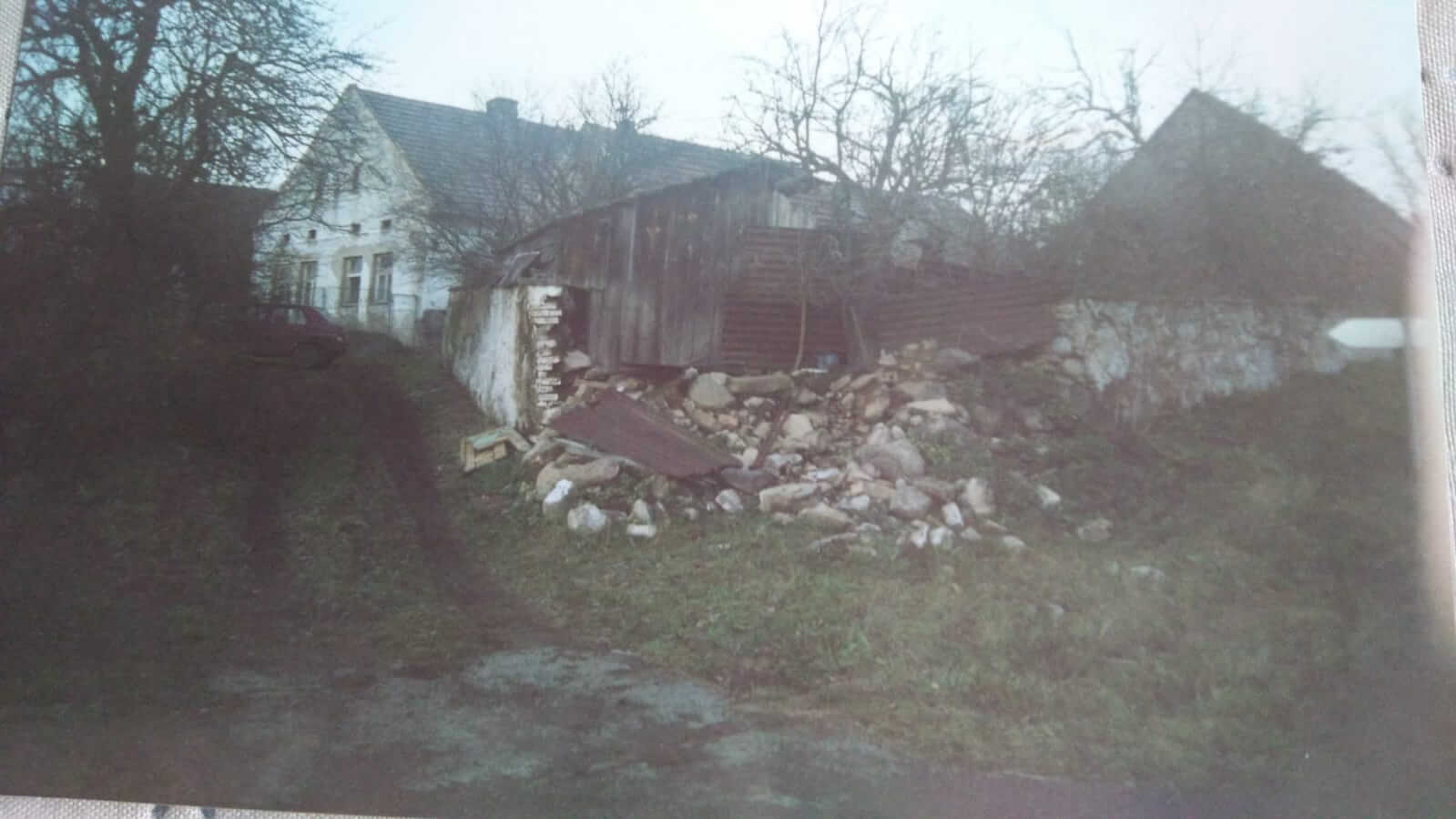 AVANT la rénovation en 2002, la clôture en pierre était fortement endommagée.